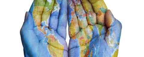 World map painted on both human hands.