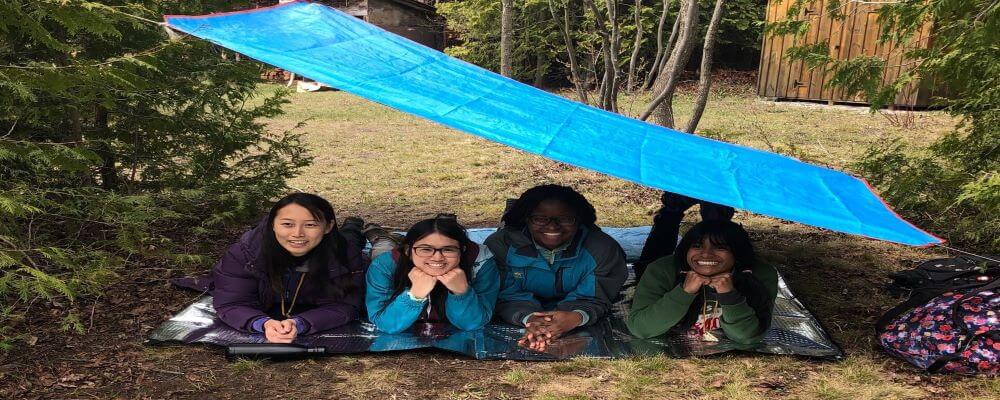 Four ERS 340 students under a tarp