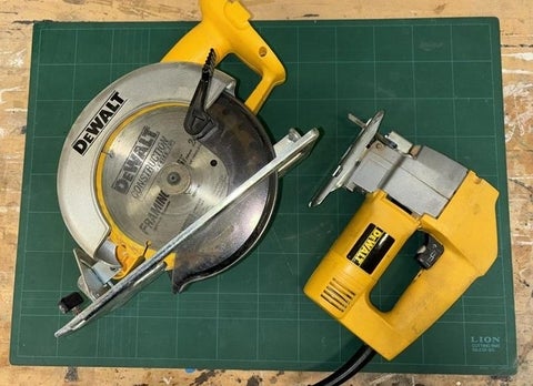 A circular saw and a jig saw displayed on a table.