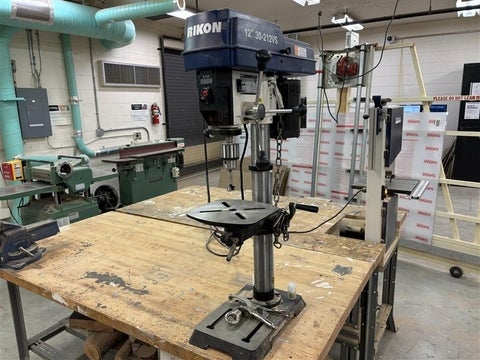 A blue and grey drill press