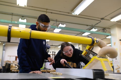 Two students using a table saw.