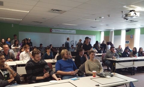 Crowd watching GIS Day presentations in the Flex Lab.