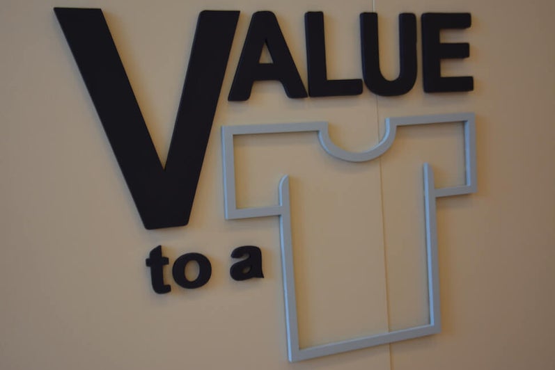 "Value to a shirt" wall sign.