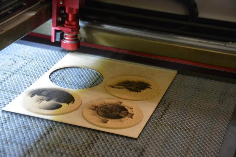 Laser cutter engraving cork coasters.