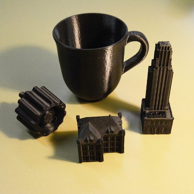 A 3D printed hotel, mansion, cup and a knob