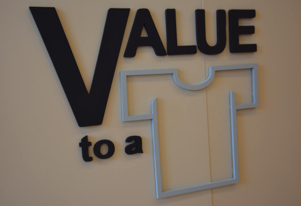 "Value to a shirt" wall sign.