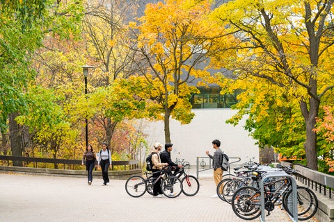 Students conversing at bike rack.