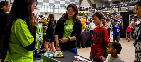 Children looking at spinning prize wheel