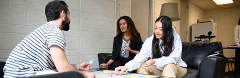 Grad students in the grad lounge playing a game