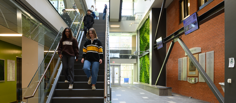 Students walking down the stairs in the EV3 building