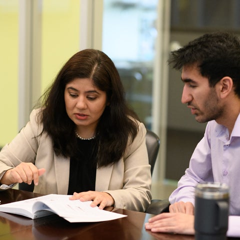 Environment and business students in a boardroom
