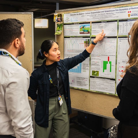 Graduate student presenting a research poster