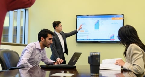 Students in an office meeting.