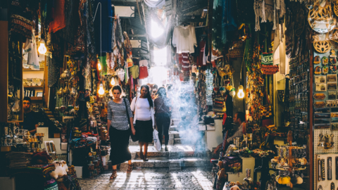 Women walking in a market.