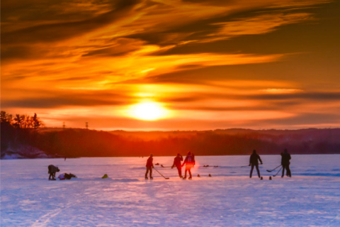 Playing hockey outside with a sunset