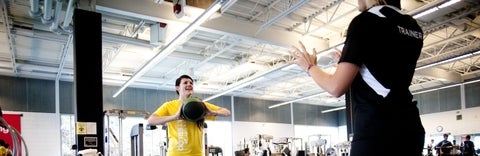 Student in PAC excersizing with a trainer