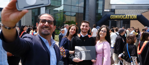 Family smiling during convocation.