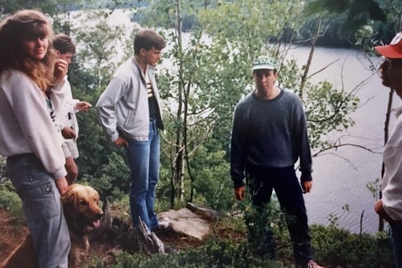 University students in the late 1980s standing on the edge of a lake