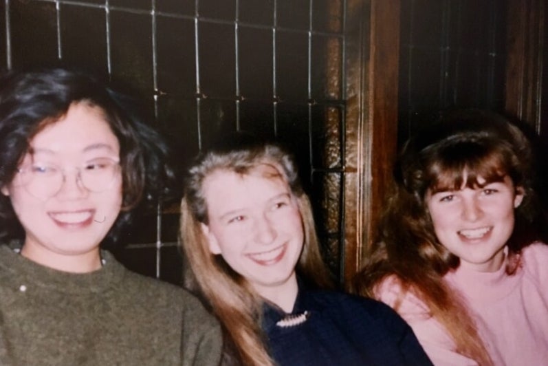 Three female university students smiling 