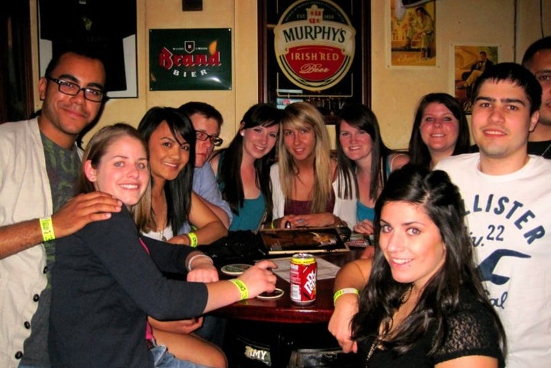 Group of university students raising drinks