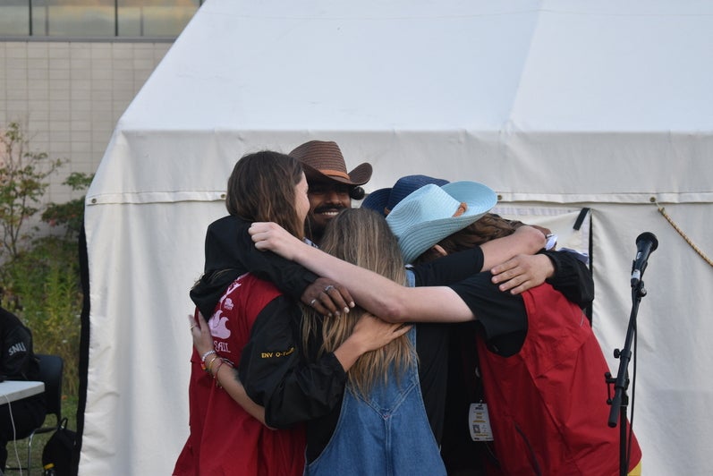 Orientation Leaders hugging at Banana Stand