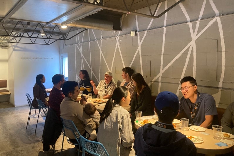 A group of people sitting at a table in a  modern restaurant. 