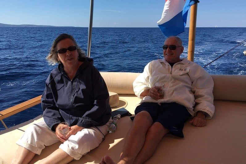 A man and a woman lounging on a boat