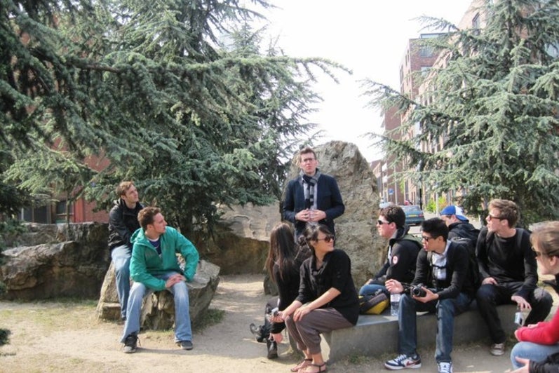 Students sitting on rocks in a park
