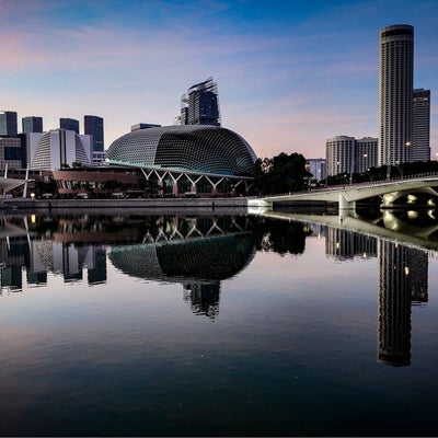 The Esplanade city skyline captured from the Merlion at sunrise in Singapore