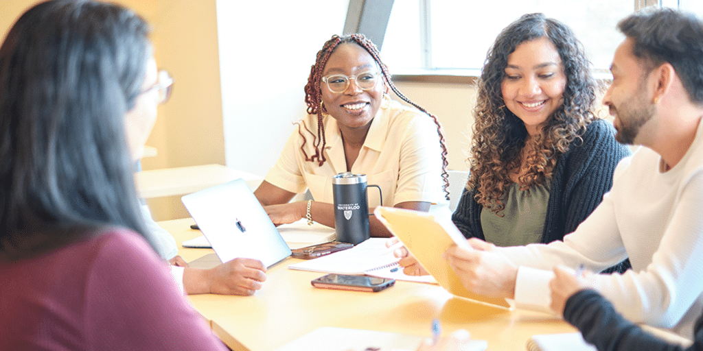 Graduate students working together in a classroom