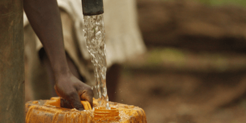 Water spout filling a canister