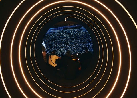 Attendees sitting down and looking at stars through a screen, inside the truck.