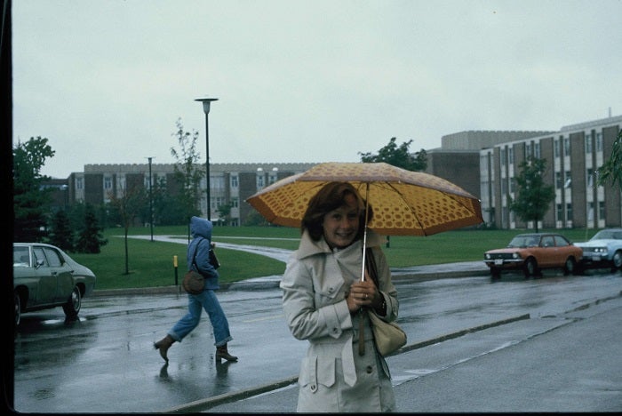 Barbara Schnick holding an umbrella in the rain. 