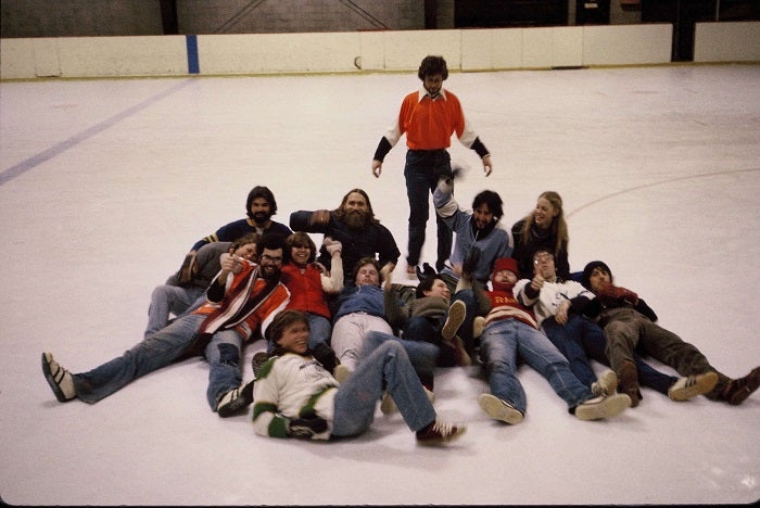 Classmates laying on the ice together after broomball