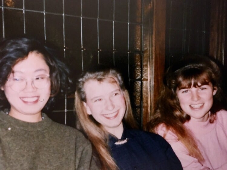 Three female university students smiling 