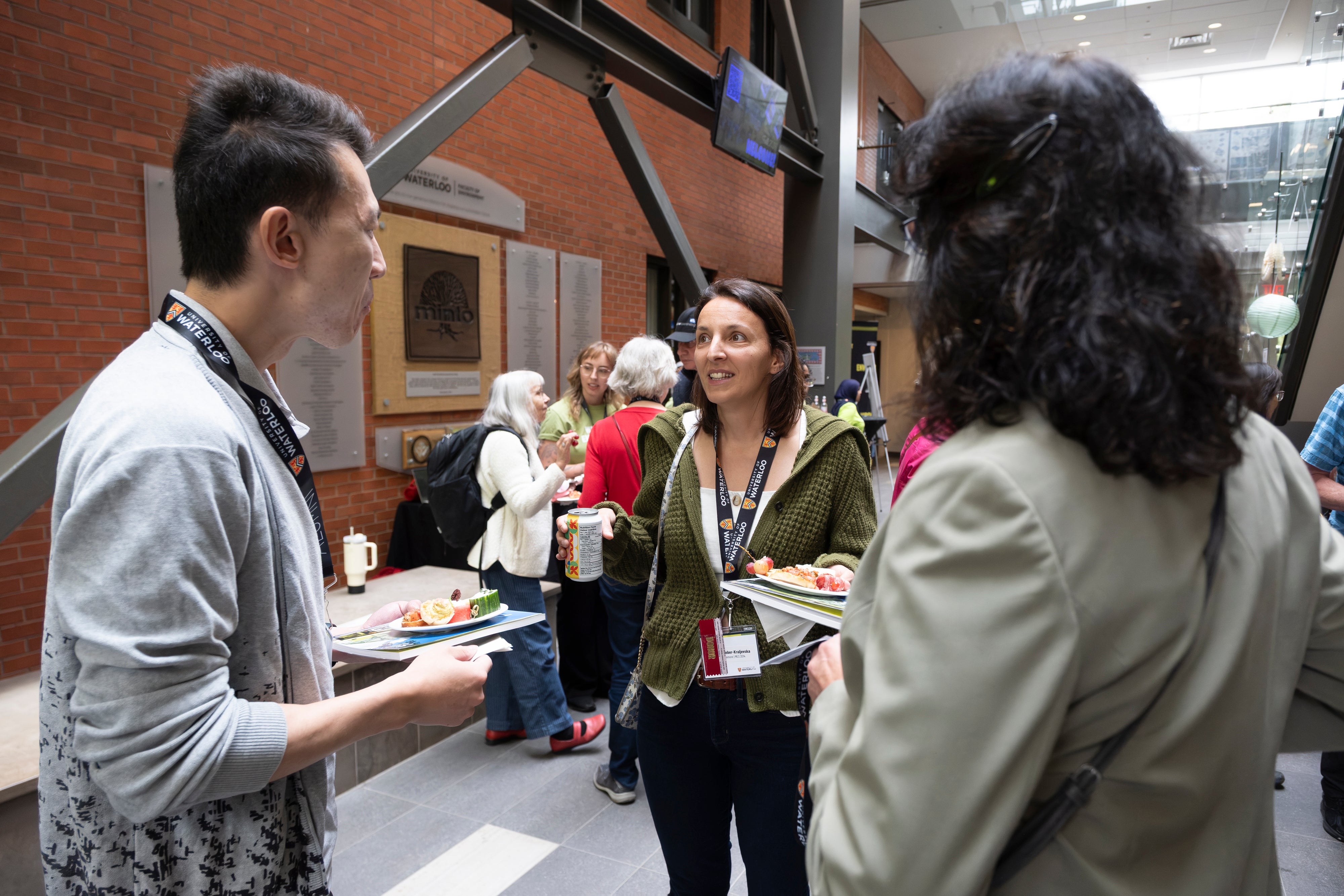 Three people in conversation at a reception.