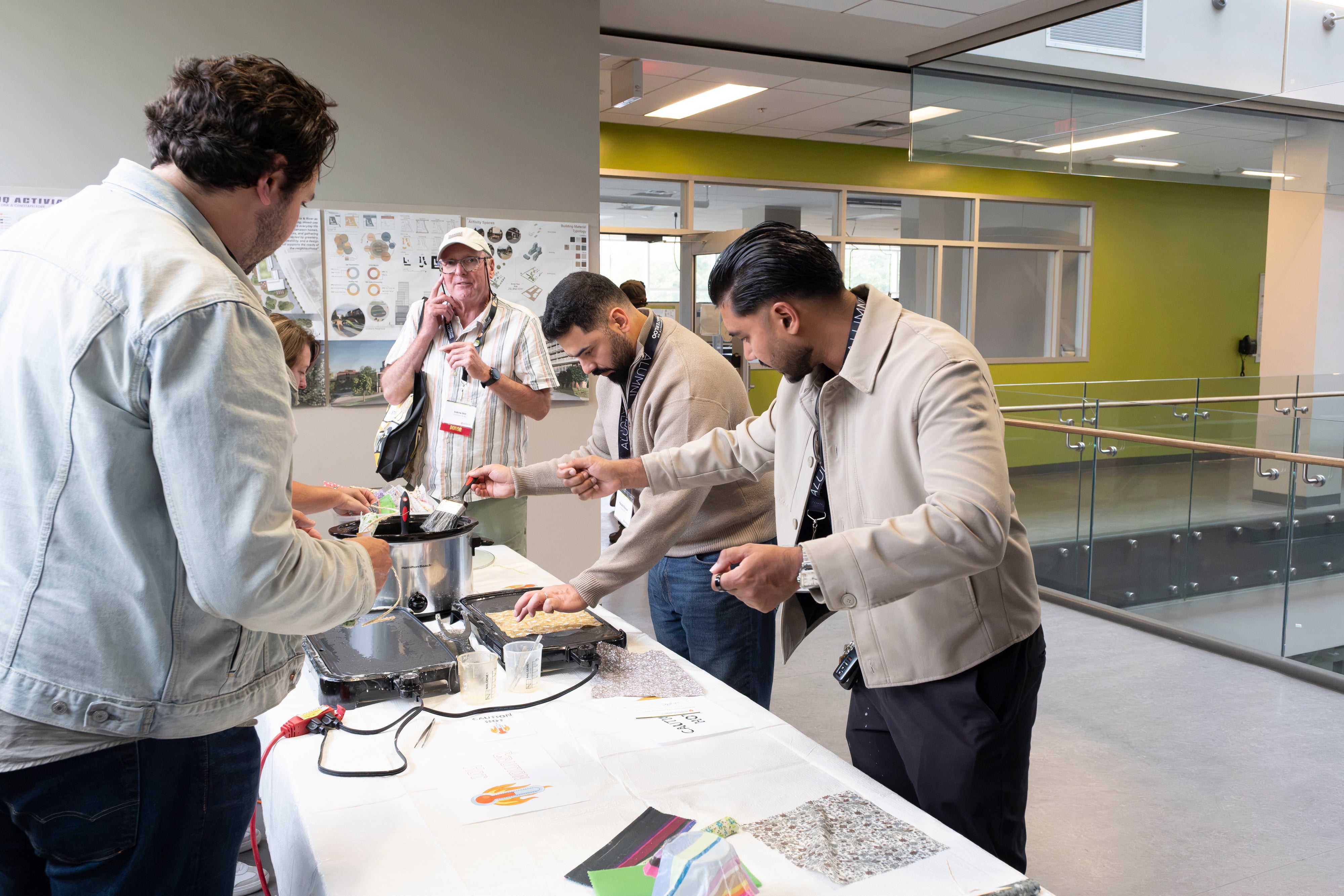 People interacting at a table with various items, participating in a craft.