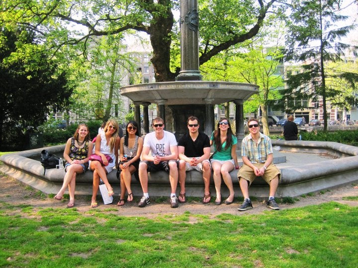 Students sitting in front of a fountain