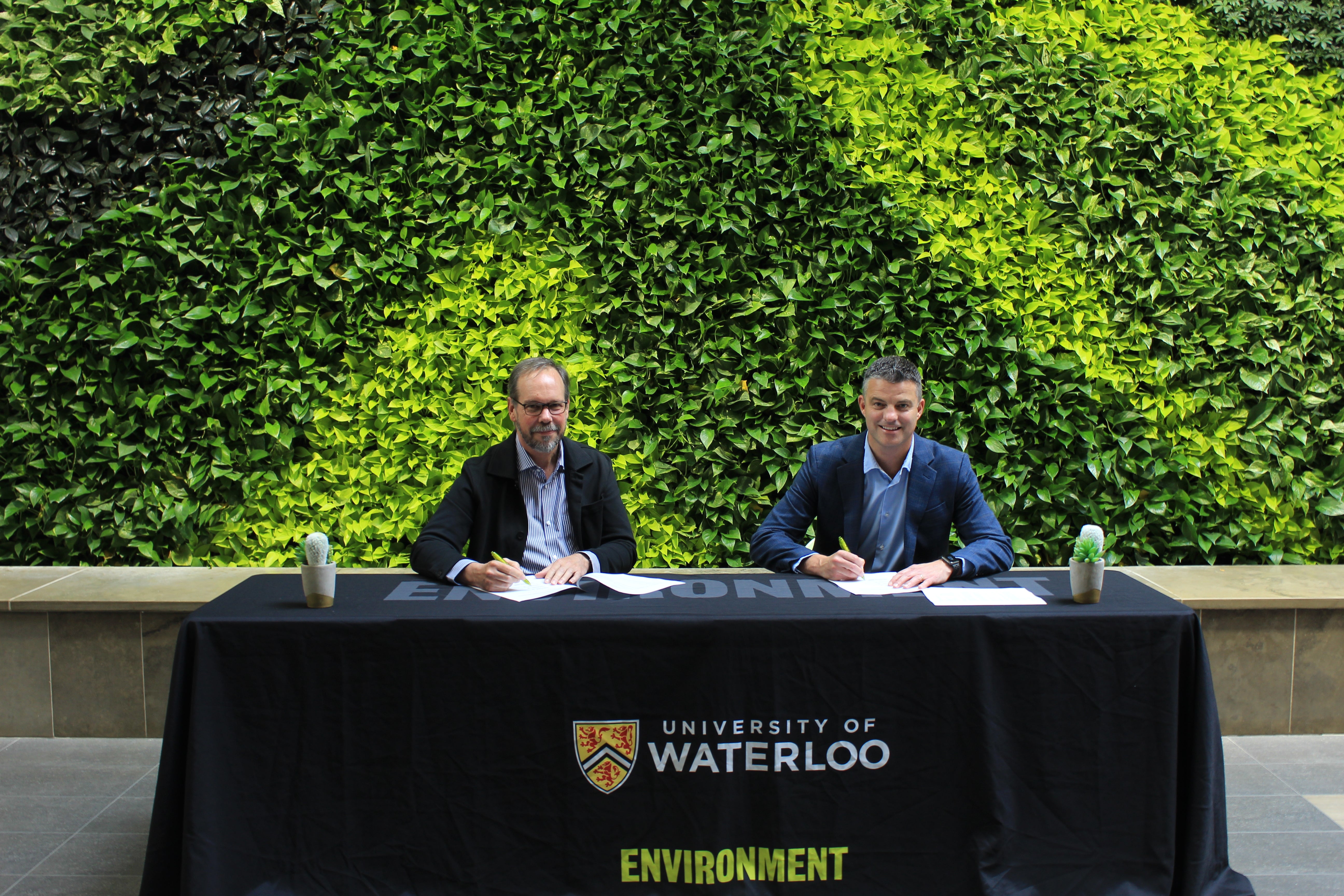 Dean Bruce Frayne and Libro Credit Union’s Scott Macleod signing the partnership agreement. 