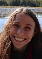 Woman smiling infront of lake