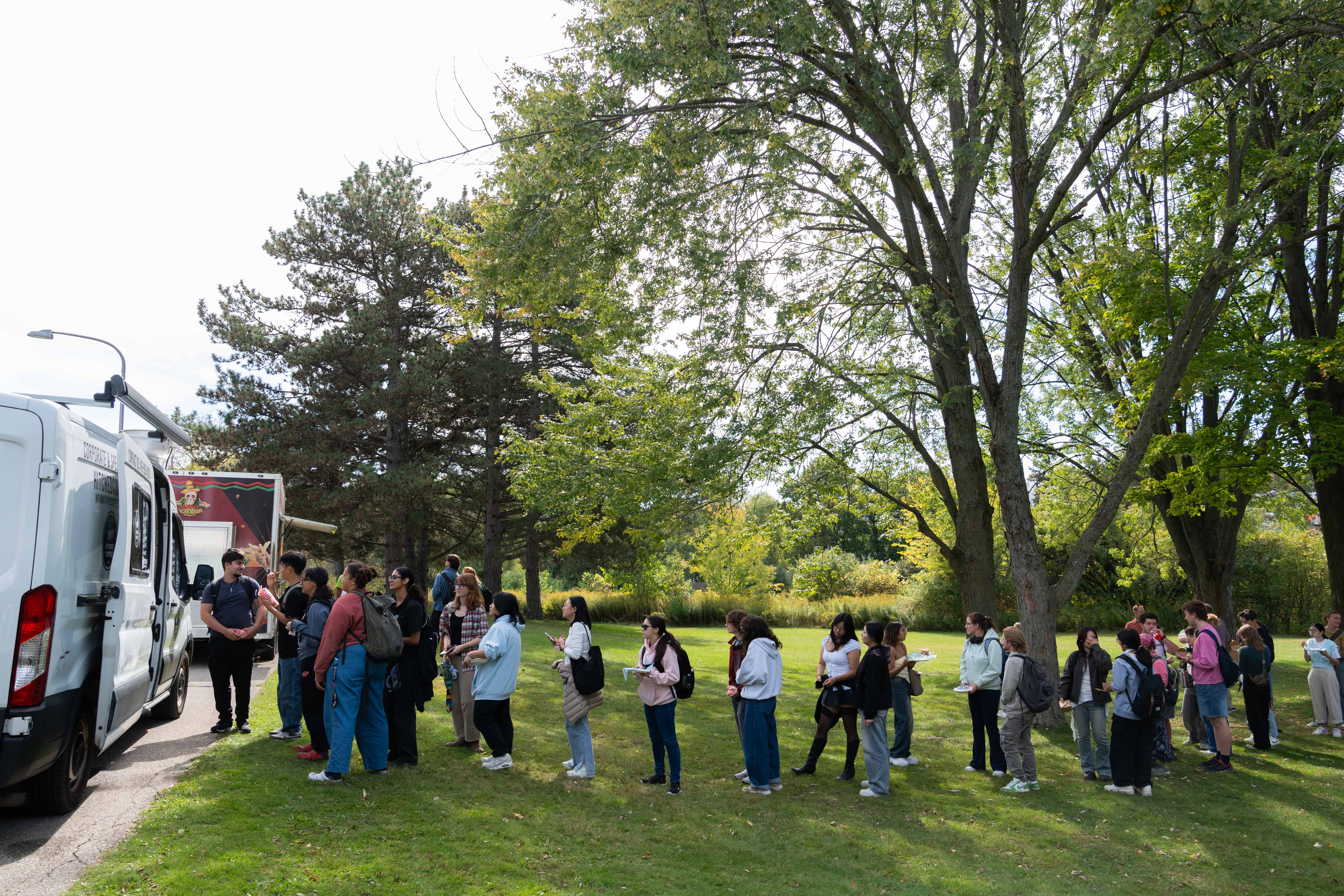 People lined up for food at a truck.
