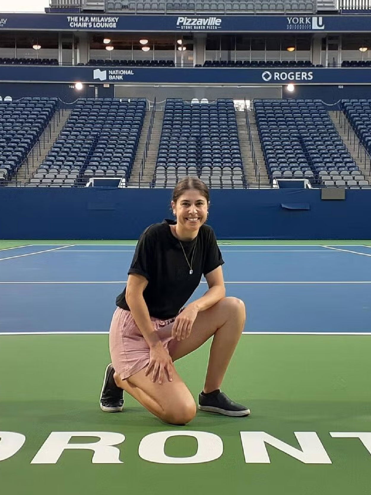 Kari Gunton, a Master of Sustainability Management candidate, in the Faculty of Environment on a tennis court