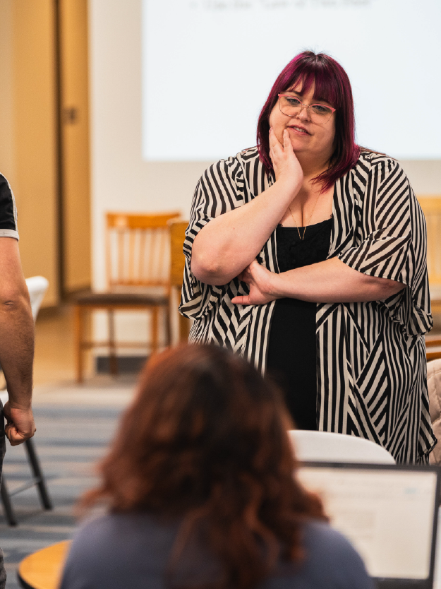 Community organizer standing and listening to students speak
