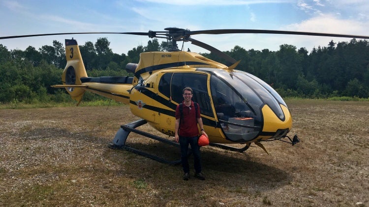 Man standing in front of helicopter