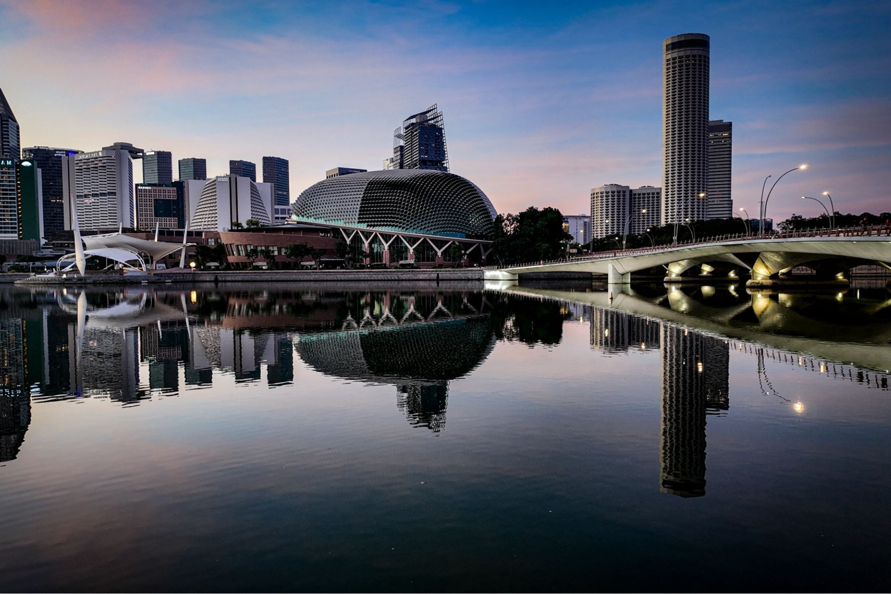 The Esplanade city skyline captured from the Merlion at sunrise in Singapore