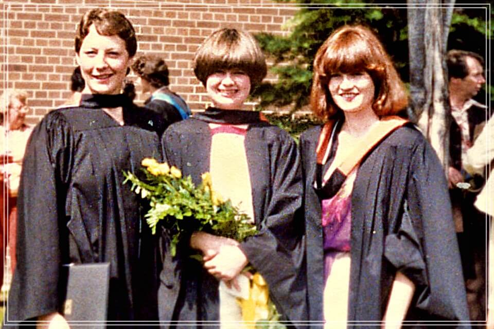 Three students standing outside in graduation gowns. From left to right: Gillian Mason, Louise Riddel, Lee Anne Doyle. 