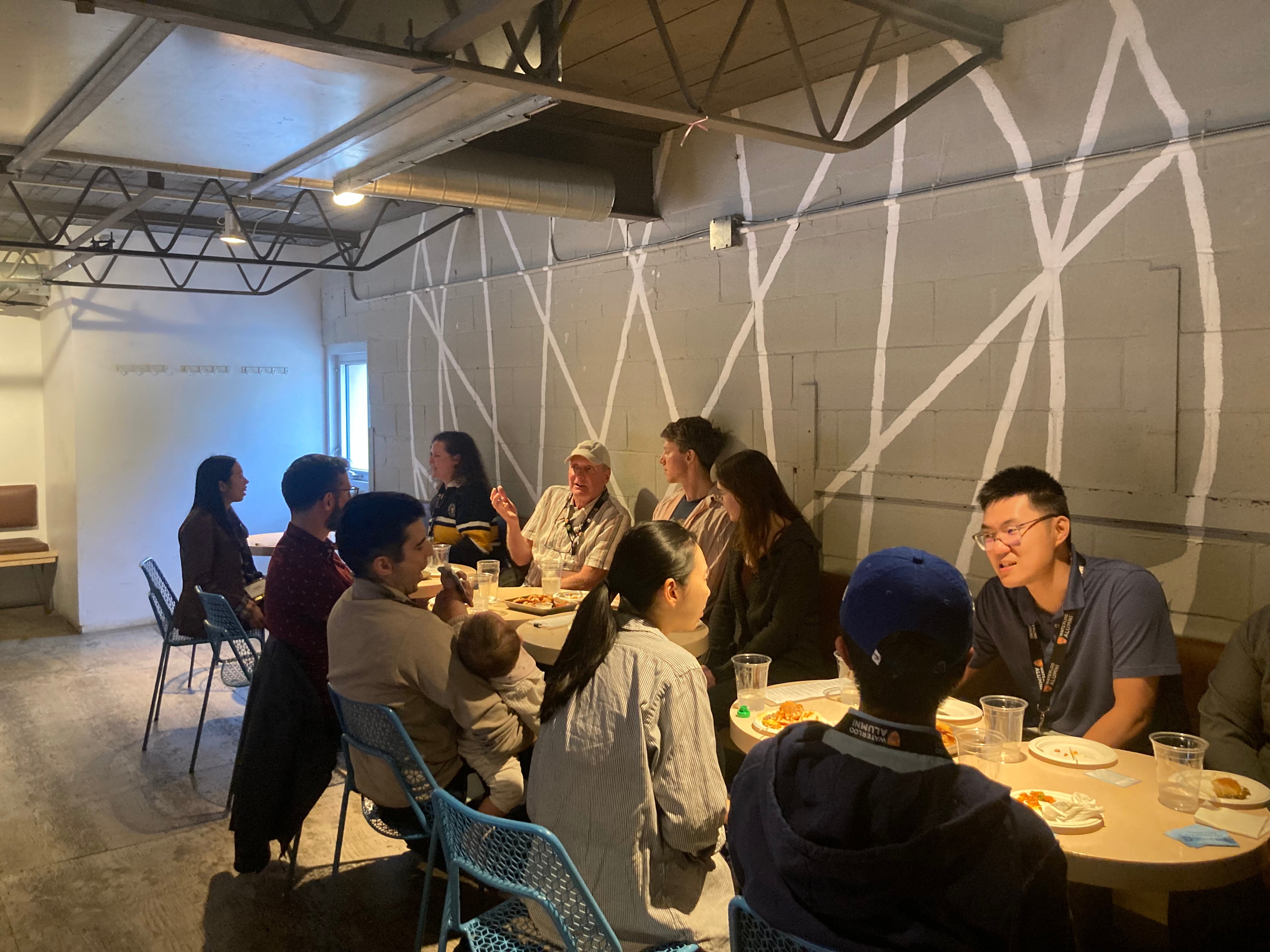 A group of people sitting at a table in a  modern restaurant. 