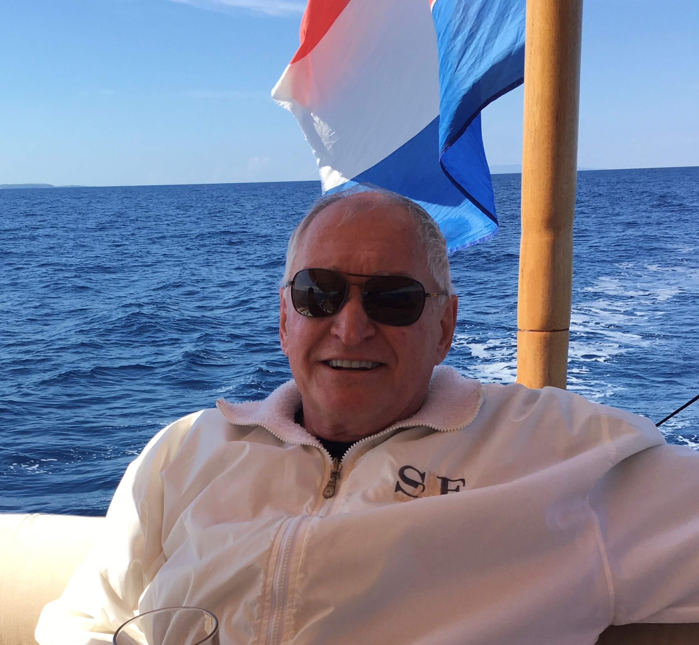 A man in sunglasses lounging on a boat