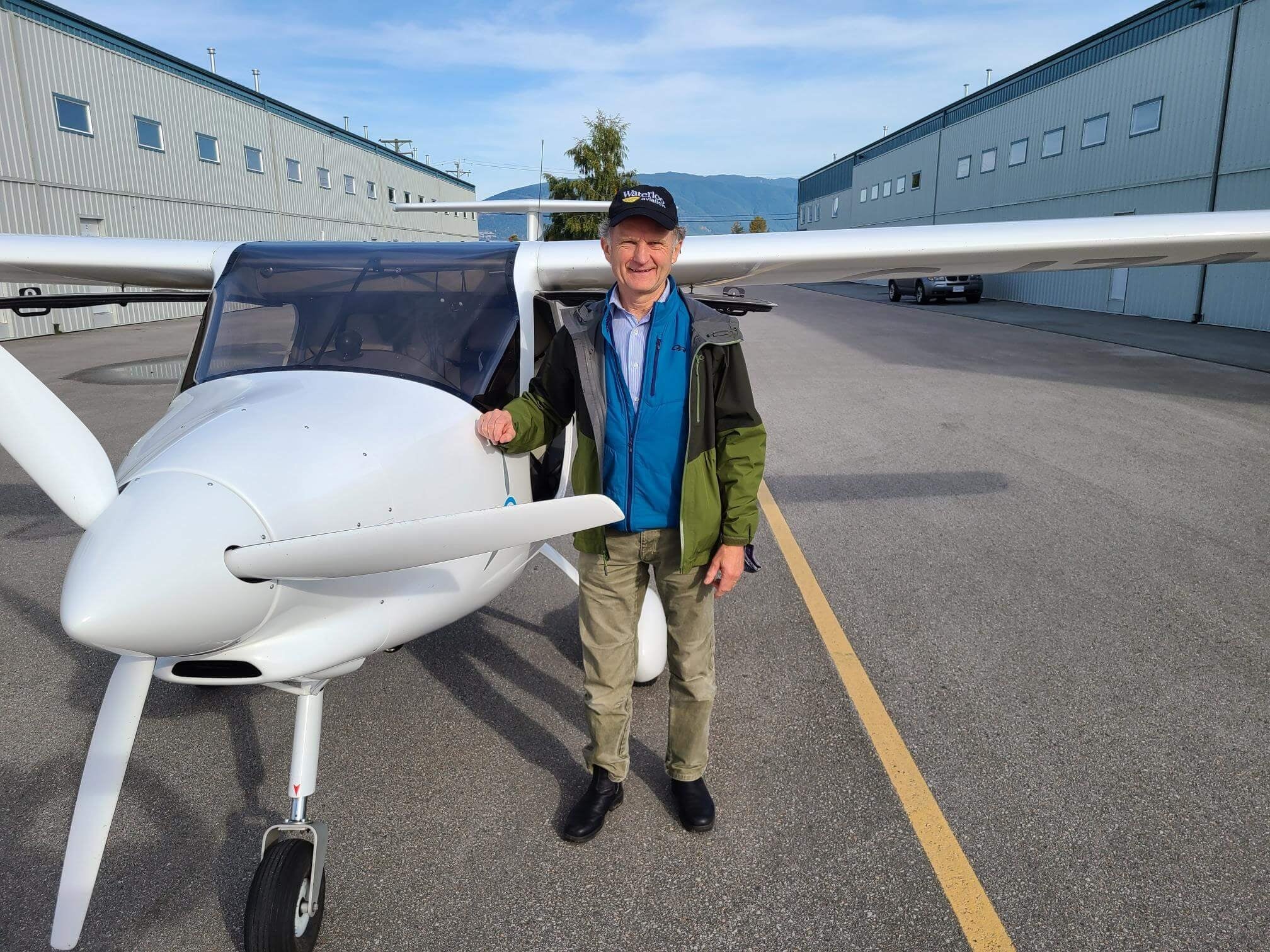 Professor Paul Parker standing beside the Pipistrel Alpha Electro aircraft 