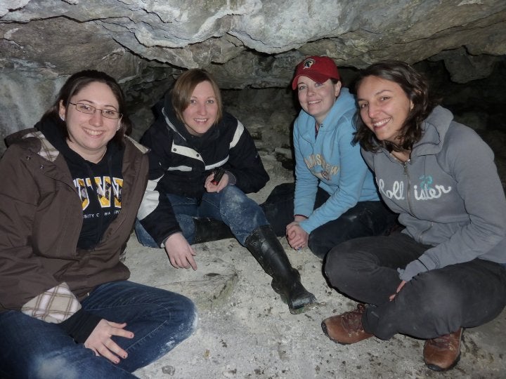 four girls in a cave 